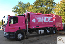 Pink rubbish truck with 10:10 design and joint messaging with Crawley Council